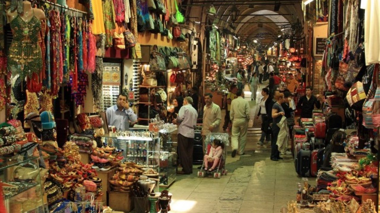 Covered bazaar lane with clothing stalls
