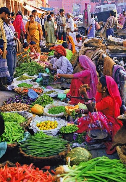 Women selling vegetables in a crowded mandi